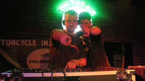 Image of DJ Nyne and DJ Chedda playing in a nightclub, two Atlanta DJs